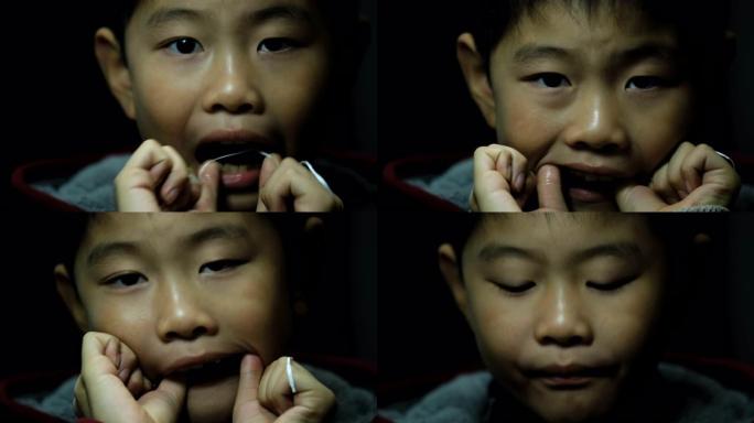 亚洲男孩使用牙线小男孩小朋友牙痛