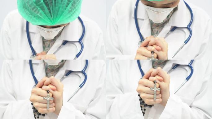 戴着面具的女医生在医院为她的病人祈祷上帝