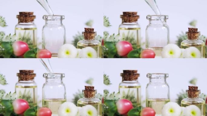 调香师在鲜花中的玻璃瓶上制作香薰香水精油。