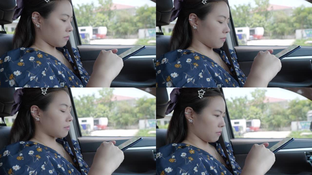 年轻女性亚洲人的场景她坐着放松，在汽车上使用智能手机搜索网站，女性使用智能手机的概念