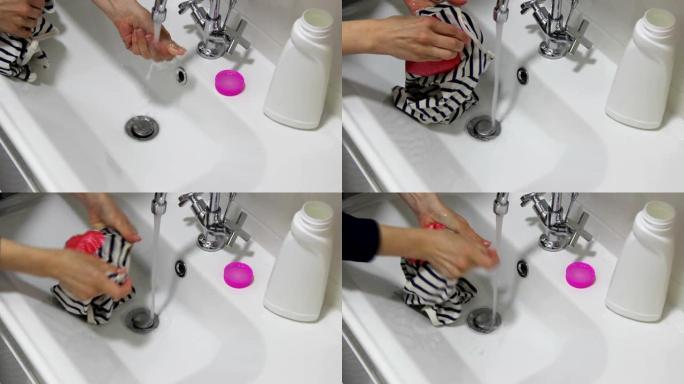 女人用去污剂洗婴儿衣服