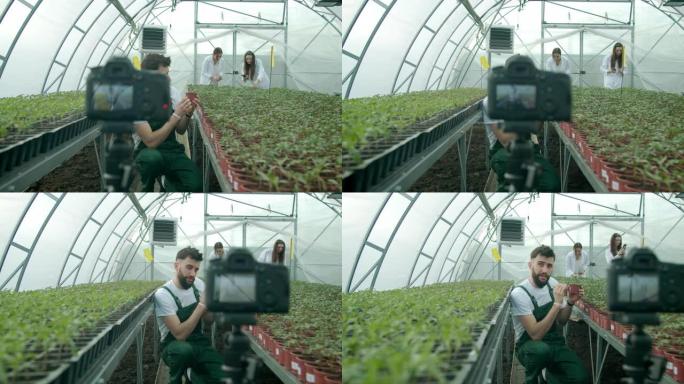 年轻的农民在温室里录像