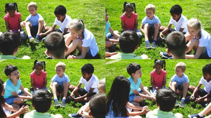 一群孩子在绿色草坪上聊天