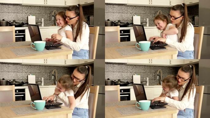 家庭办公室。年轻女子在家用电脑工作。小女儿阻止妈妈工作。孩子想玩
