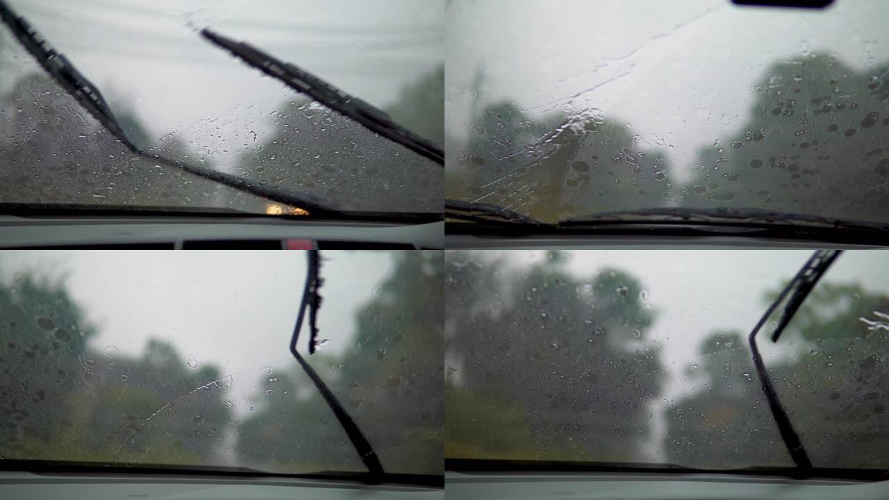在大雨中行驶，透过挡风玻璃观看。