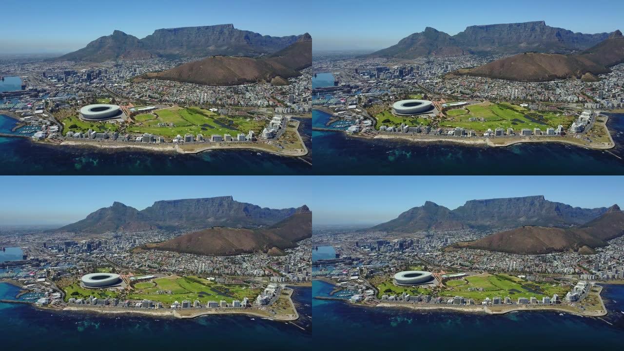 4k镜头鸟瞰开普敦市中心的体育场和绿色山丘，南非