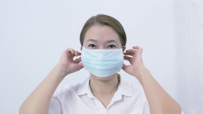 亚洲女性戴着医用口罩，以防止空气中的细菌。卫生概念防止细菌和细菌的传播，避免冠状病毒感染。