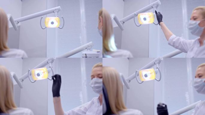 牙医打开并将灯靠近，开始检查口腔。现代诊所的牙科咨询。