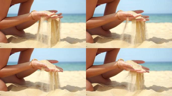 年轻的女士在海洋海滩上玩耍倒沙