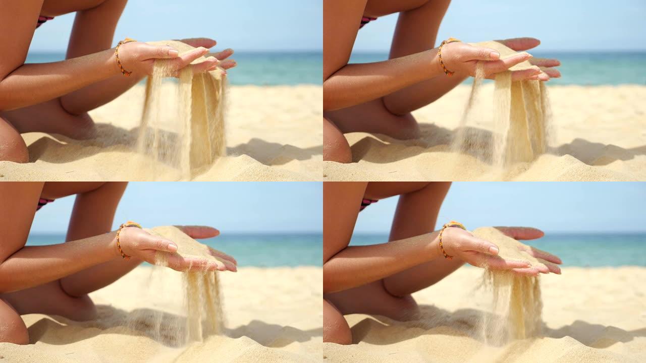 年轻的女士在海洋海滩上玩耍倒沙