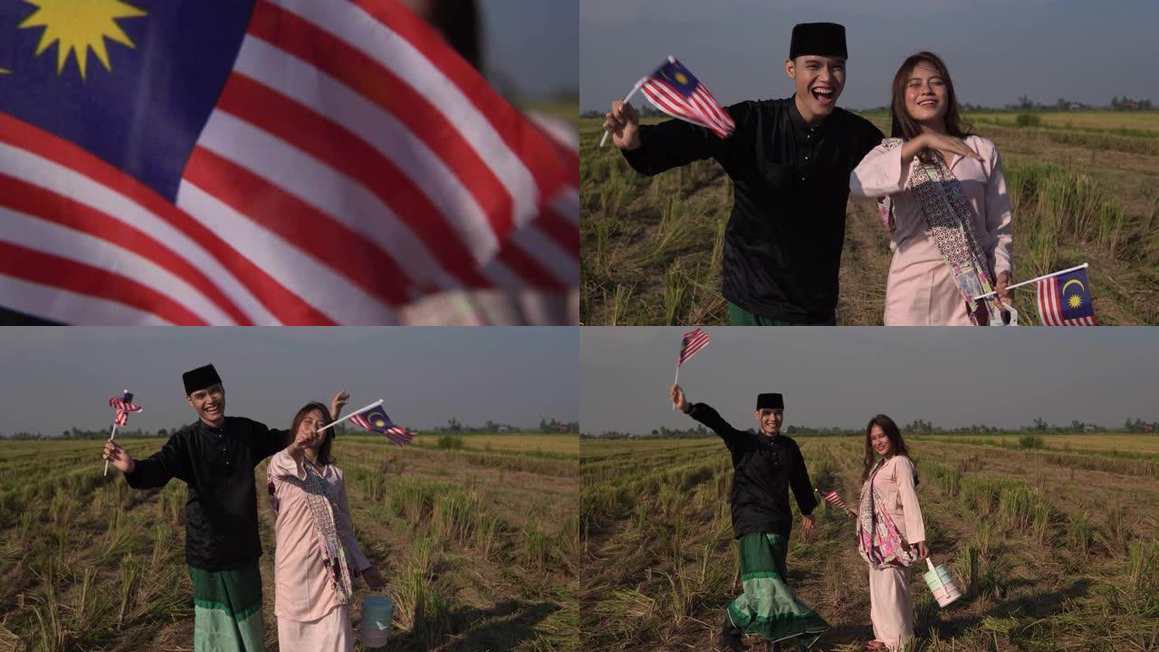 年轻的亚洲男人和女人拿着和挥舞着国旗