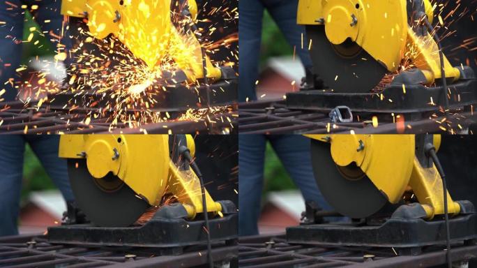 工人使用电动磨床切割钢材。钢切割机。慢动作。