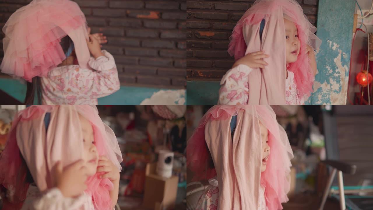 慢动作特写快乐亚洲女孩的脸用粉色裙子装扮成公主。