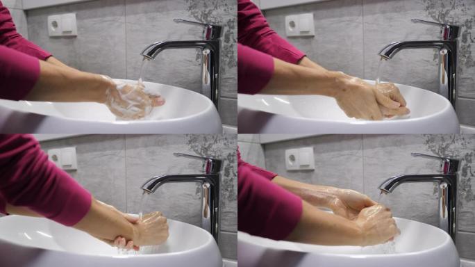 女人正在洗手，以避免被广泛的电晕病毒新型冠状病毒肺炎感染。面目全非的人用抗菌肥皂彻底洗手。4k视频实