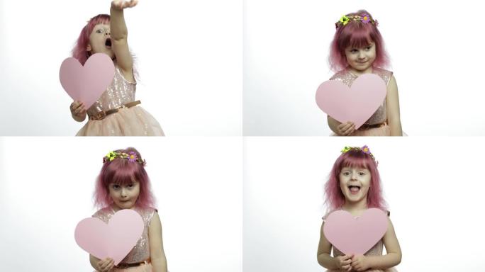 童女公主抱着粉红色的纸心。母亲节，情人节概念