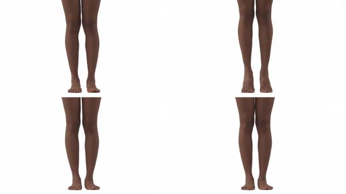 特写的苗条女性的腿。非洲妇女脚跟和脚趾抬起。孤立，在白色背景上