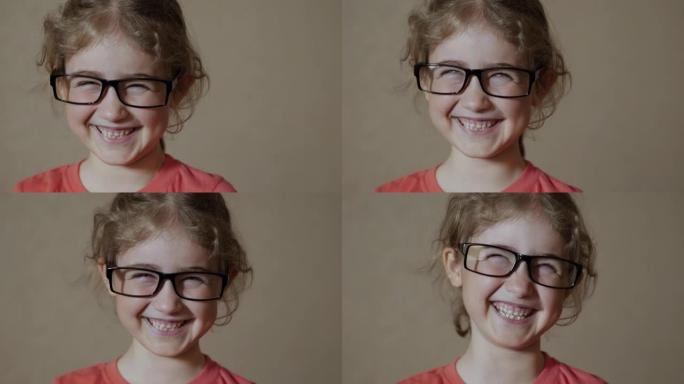 戴眼镜的肖像小女孩看着相机。年轻的孩子戴着眼镜看着相机开心地笑。特写。好奇的小女孩肖像。面对有趣沉思