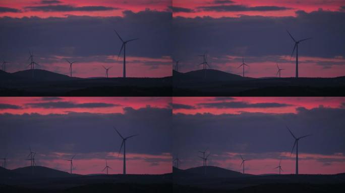 西班牙安达卢西亚日落时山丘上的风力涡轮机
