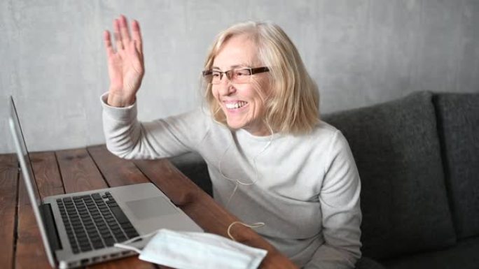 技术、老年和人的概念 -- 在冠状病毒冠状病毒19大流行期间，快乐的老年女性戴着口罩工作，在家用笔记