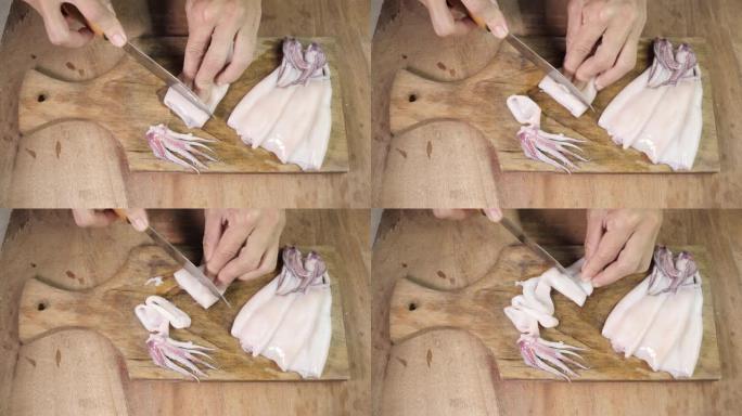 女厨师小心地将鱿鱼生鱿鱼切成木砧板上的环，近距离拍摄