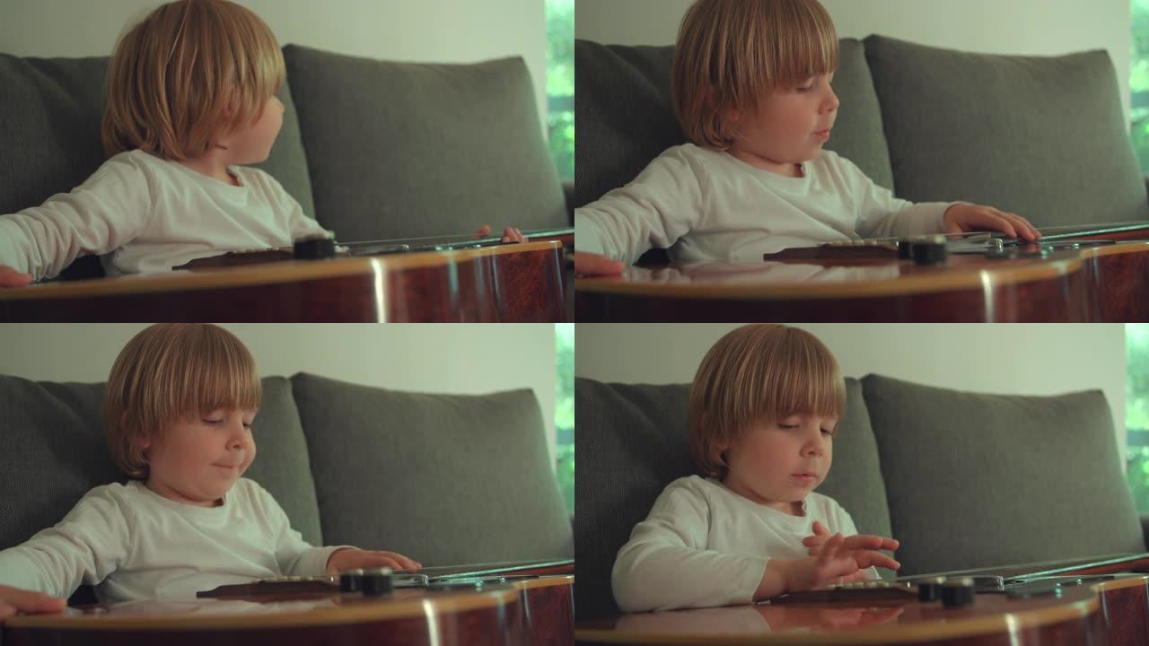 蹒跚学步的男孩在沙发上弹吉他