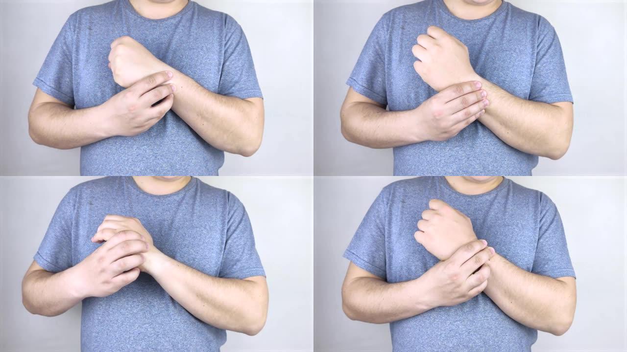 一个男人的手腕疼。创伤学家检查一只手。手腕疼痛是隧道综合征或扭伤，肌腱退化，关节炎的征兆