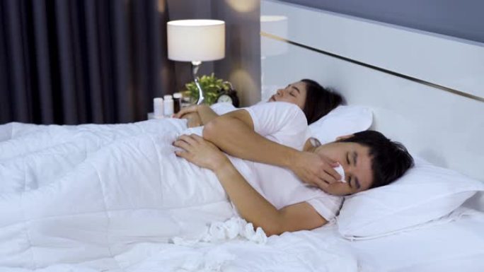 生病的男人在妻子在家睡觉时打喷嚏
