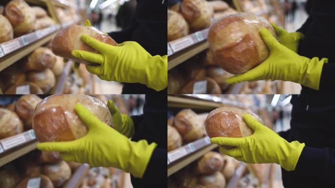 戴着面具和橡胶手套的人在超市里选择面包