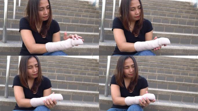 一个美丽的亚洲女孩摔断了手臂