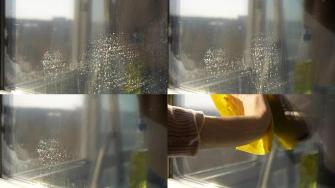 女管家打扫窗户清洁剂，特写镜头。