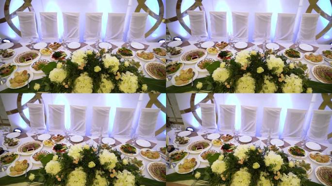 漂亮的婚礼装饰品。优雅的婚礼桌，配有美味的菜肴和饮料