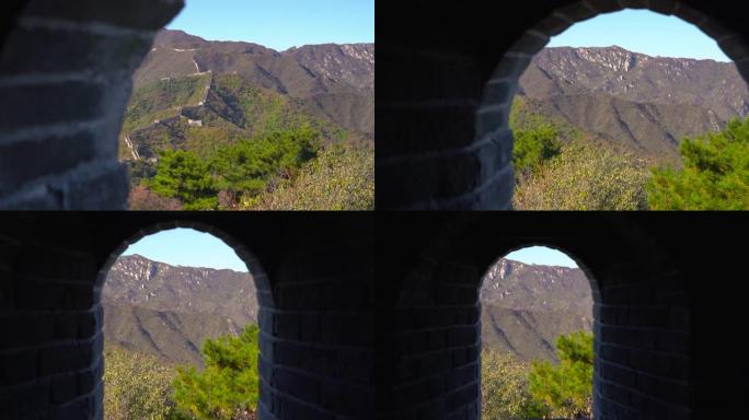 Steadicam拍摄了从山边升起的中国长城。摄像机在watch望塔的通道中移动，并从墙上的窗户显示