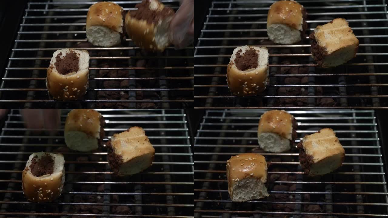 双手在芝麻面包中烧烤巧克力，然后食用，生活方式。