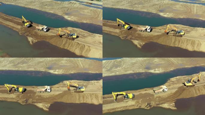 两辆黄色挖掘机的鸟瞰图，卡车在采石场工作。重型设备正在对土地进行分级。概念生产与建设