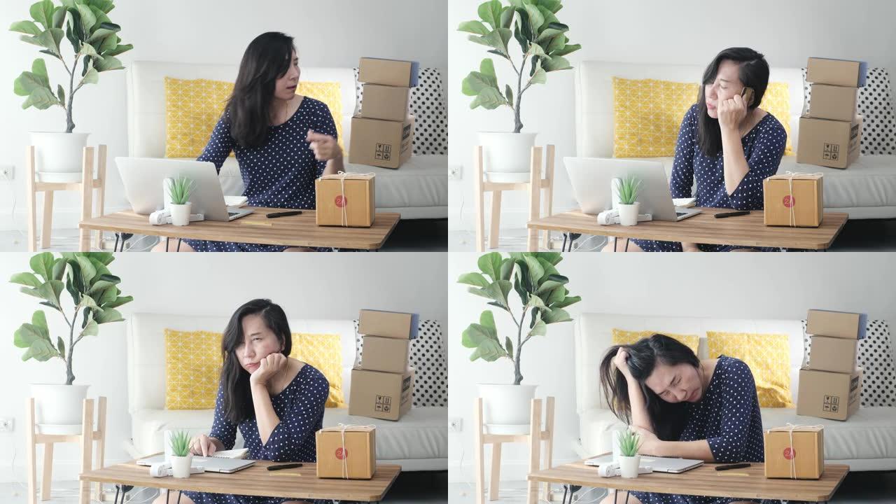 沮丧的亚洲妇女坐在家里的地板上，附近有棕色的盒子包裹。她的生意亏本了。