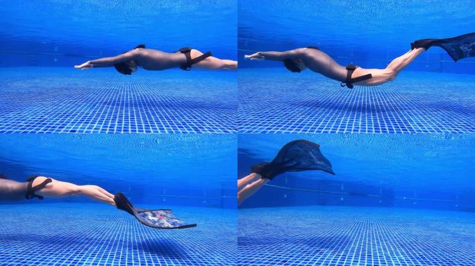 水下特写镜头跟踪女人穿一件长袖比基尼剪裁潜水服做动态呼吸暂停游泳鳍海豚踢单鳍