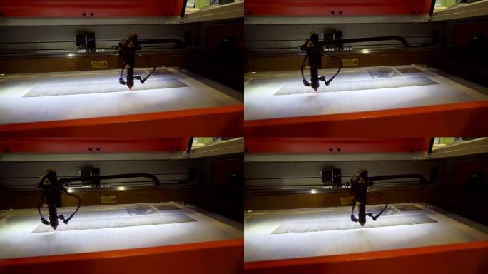 3D打印机激光束在木板上燃烧图案特写