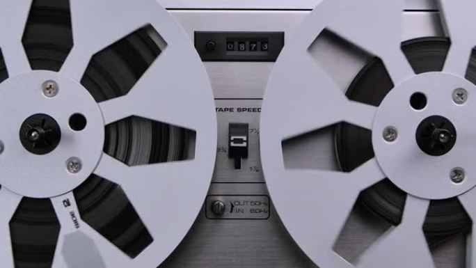 旧模拟磁带录音机的旋转接纸盘。磁带录音机的形式，其中记录介质被保持在不在盒式磁带中的卷轴上。特写
