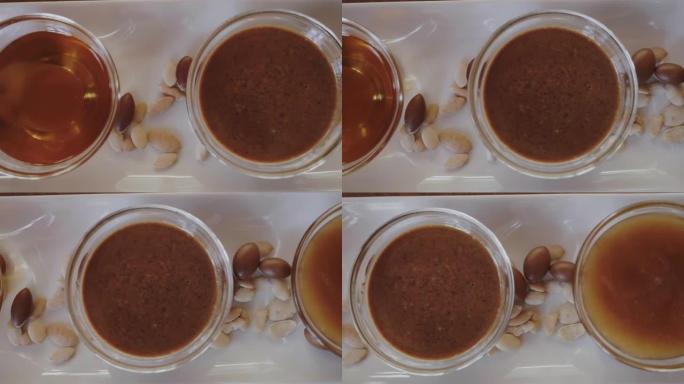玻璃碗上纯正宗的摩洛哥坚果油，摩洛哥坚果蜜以及由摩洛哥坚果油和杏仁制成的传统Amlou。
