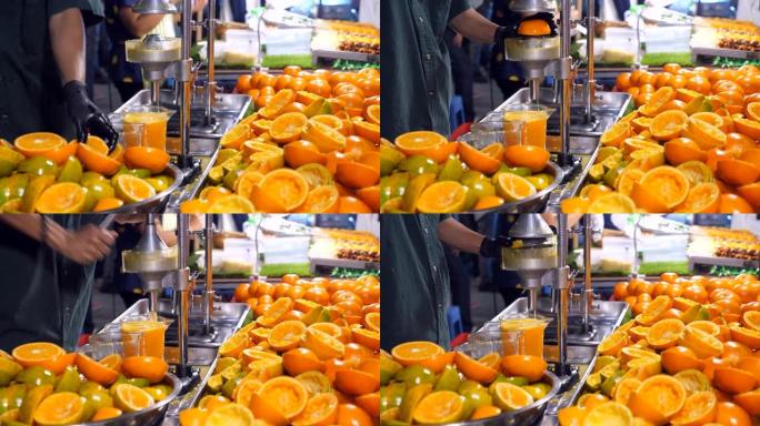 夜间街头食品中的特写橙汁摊贩
