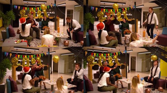 迷人而兴奋的不同同事群体在办公室享受他们2021的新年派对
