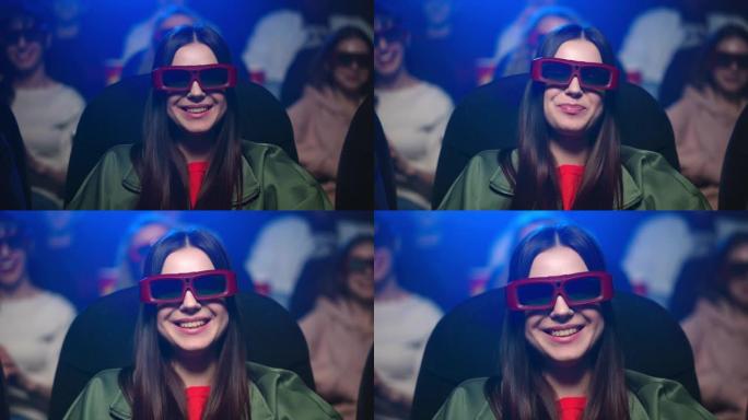 快乐的女人在电影院玩得开心。用3d眼镜观看电影的女孩