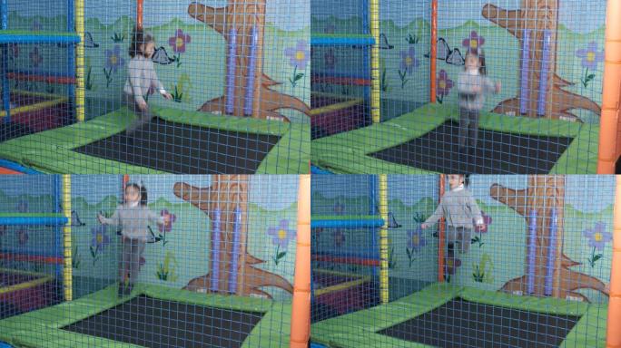 6岁女孩在游乐中心蹦床上跳跃