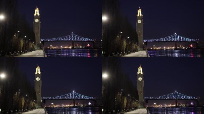 蒙特利尔旧港口钟楼和夜间照明的雅克-卡地亚大桥
