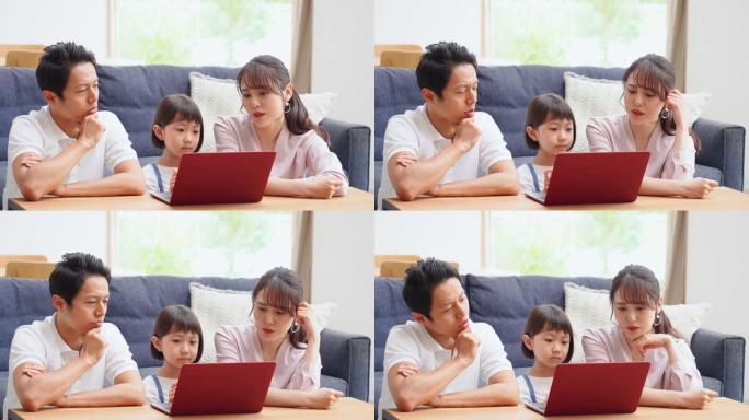 亚洲家庭在家中使用笔记本电脑