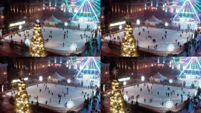 圣诞节和新年前夕，人们在城市广场的溜冰场上滑冰。鸟瞰图。户外放松和娱乐