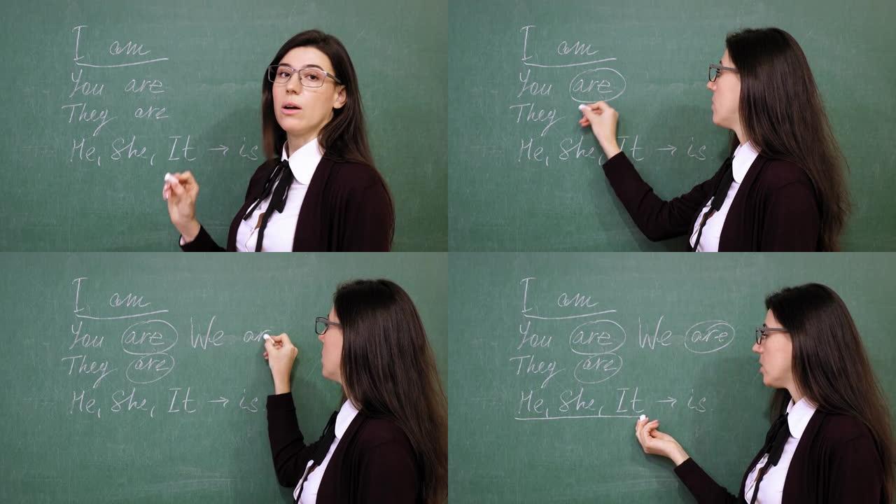 在线教育。女老师正在举办在线英语课。她在学校课堂上用粉笔在黑板上写语法规则。远程教学。课堂直播视频流