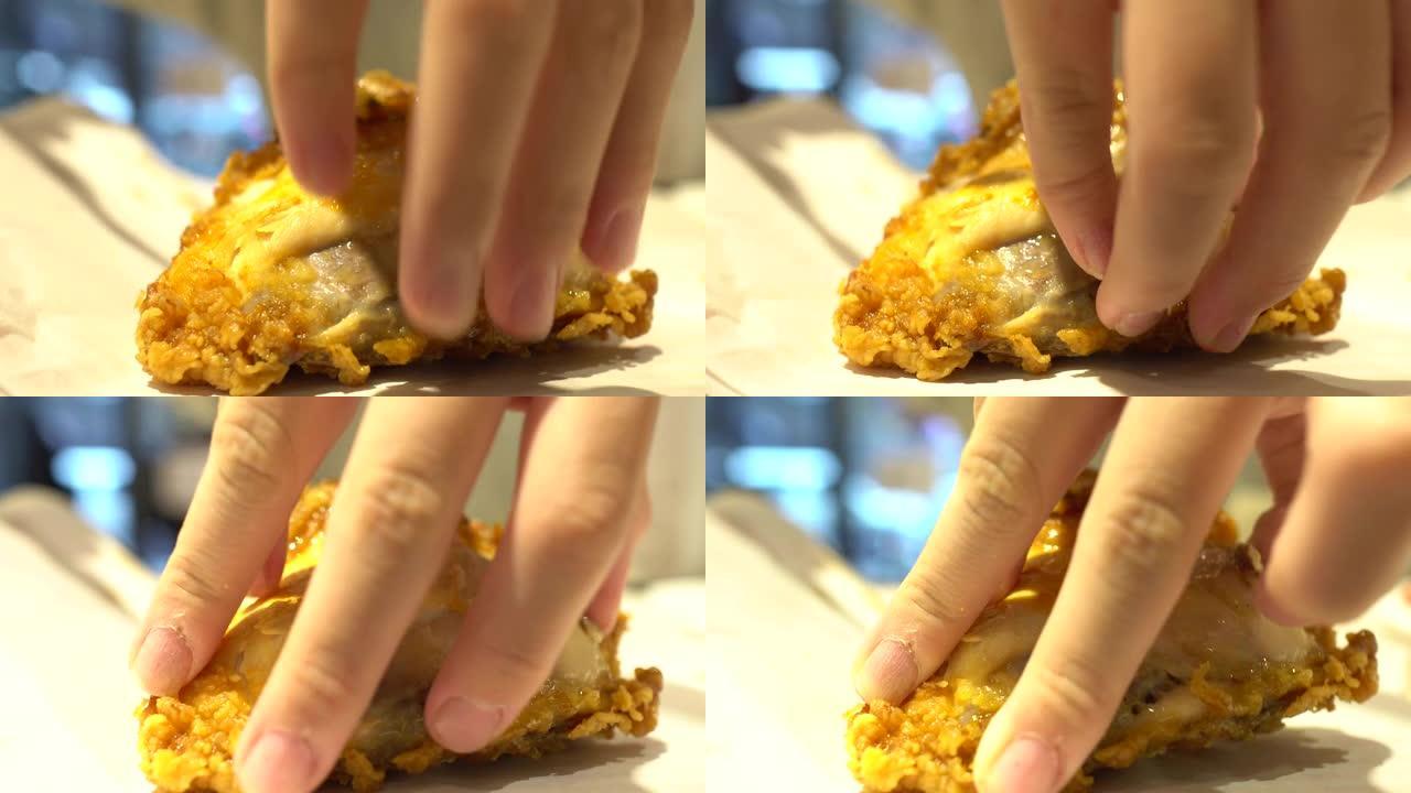 一个小孩在快餐店吃炸鸡。准备用手撕鸡。
