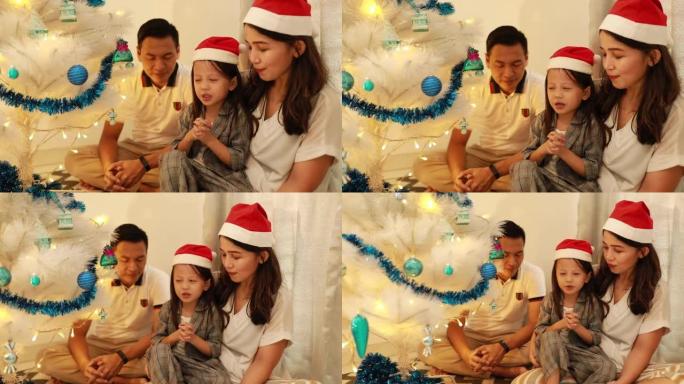 装饰圣诞树的亚洲家庭