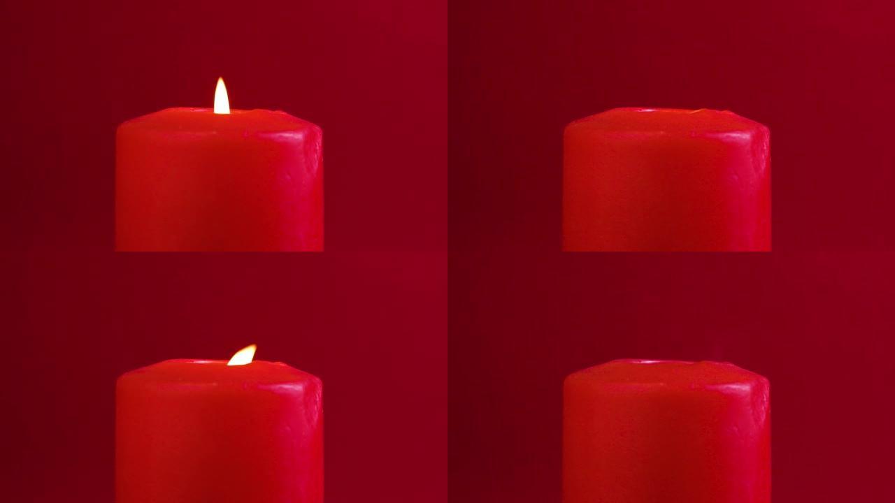 红色蜡烛燃烧并在红色背景下熄灭。视频剪辑高清